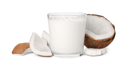 Glass of delicious vegan milk and coconut pieces on white background