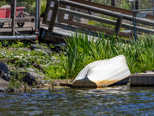 Small boat upside down on lakeshore