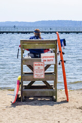 Beach lifeguard on perch in summer
