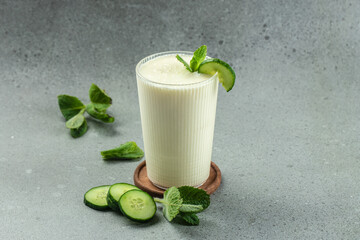 ayran drink with mint and cucumber on a white background, clean eating for weight loss. place for text