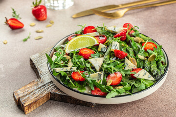 Green asparagus, strawberry salad, Concept healthy and balanced eating. place for text, top view