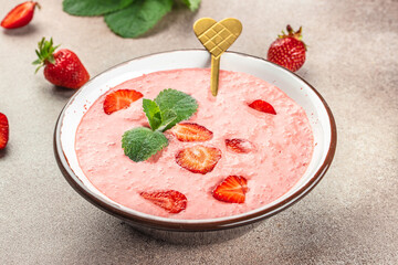 tasty strawberry smoothie in bowl. Delicious breakfast or snack, Clean eating, dieting, vegan food concept. top view