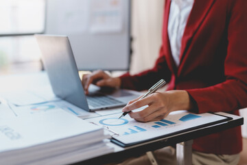 Businesswoman hand pointing to financial data graph. Business Analysis and Investment. Accountant checking business income and profits.