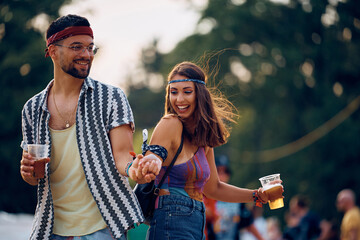 Happy couple dancing and having fun on music festival.