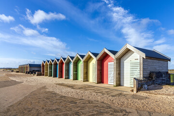 Line of colourful British beach huts at Blythe, Northumberland on the Northumbria Coast.