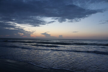 Sunrise over crashing waves