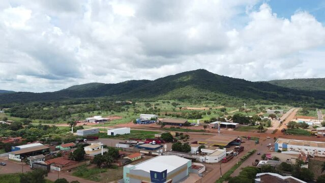 aerial images of city landscapes with mountains and horizon, blue sky and green trees, green vegetation, sun