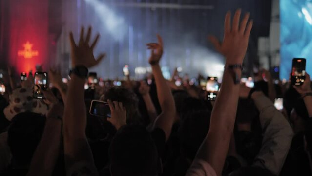 Concert people crowd applause and dancing, festival music show stage. Crowd singing artist cheering, rock events. 