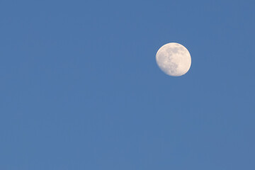 Full moon in clear dark blue night sky