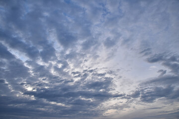 Naklejka na ściany i meble Dramatic brightly lit blue sunrise cloudscape