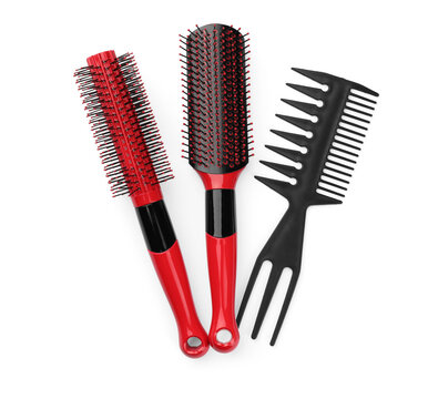 Plastic hair brushes and comb isolated on white, top view