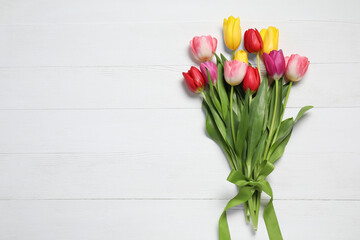 Beautiful colorful tulips on white wooden background, flat lay with space for text