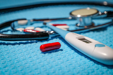 Medicines and medical utensils on blue background