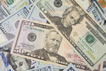 One hundred dollars close-up in large quantities lie on the table. Much money.