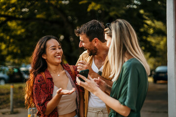 Embraced group of diverse friends meeting in the city, ready to make a city tour and have fun during a summer day