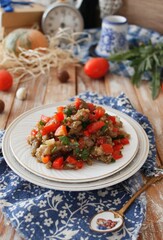 A warm salad of baked eggplant and peppers with tomatoes