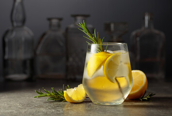 Fototapeta premium Cocktail gin tonic with ice, rosemary, and lemon.