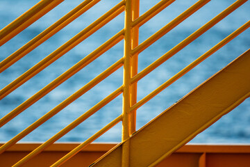 Yellow metal hand railings on a ferry.