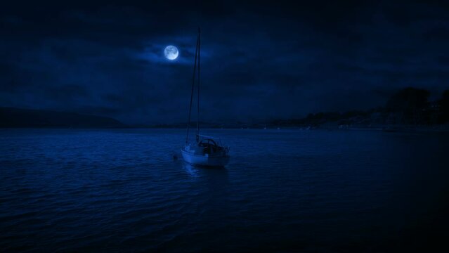 Circling A Yacht At Night With Moon Above
