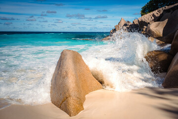 Big granite rocks on the Grand Anse beach. La Digue island, Seychelles. Tropical landscape with sunny sky.