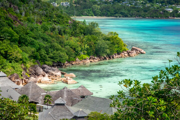Praslin Seychelles tropical island with withe beaches and palm trees. Aerial view of tropical paradise bay with granite stones and turquoise crystal clear waters of Indian Ocean