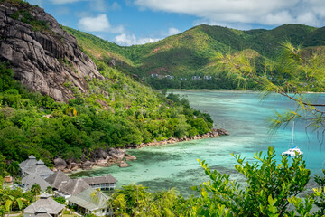 Praslin Seychelles tropical island with withe beaches and palm trees. Aerial view of tropical paradise beach with white sand and turquoise crystal clear waters of Indian Ocean