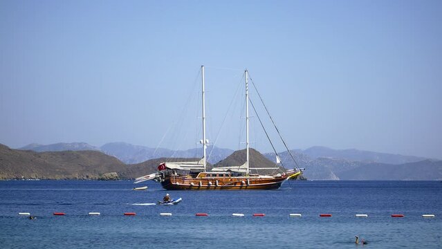 Typical Turkish style gulet yacht sailing into shallow bay. Datca resort 70 km away from Marmaris and reachable by ferryboat from Bodrum or you can reach these destinations by driving yourself or taki