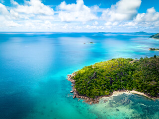 Praslin Seychelles tropical island with withe beaches and palm trees. Aerial view of tropical paradise bay with granite stones and turquoise crystal clear waters of Indian Ocean