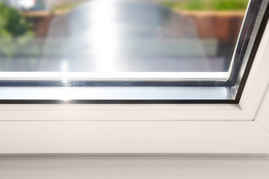 Bottom detail of window frame of PVC profiles. Window frame glass. Energy efficient, safety window glazed. Rubber seal gasket.