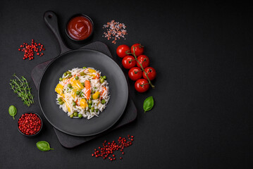 Delicious fresh white boiled rice with vegetables carrots, peppers and asparagus beans on a ceramic plate