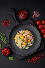 Delicious fresh white boiled rice with vegetables carrots, peppers and asparagus beans on a ceramic plate