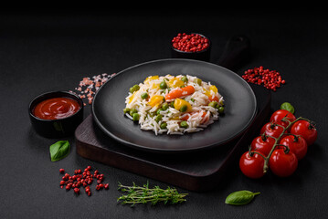 Delicious fresh white boiled rice with vegetables carrots, peppers and asparagus beans on a ceramic plate