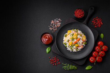 Delicious fresh white boiled rice with vegetables carrots, peppers and asparagus beans on a ceramic plate