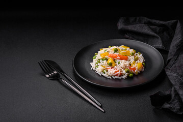Delicious fresh white boiled rice with vegetables carrots, peppers and asparagus beans on a ceramic plate