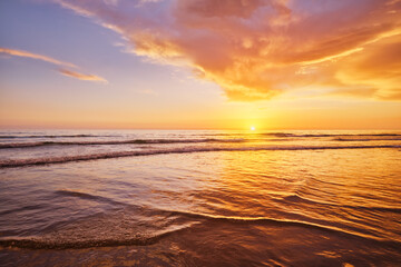 Atlantic ocean sunset with surging waves at Fonte da Telha beach, Costa da Caparica, Portugal
