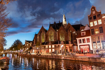 The Oude Kerk in the center of Amsterdam, Netherlands at night - 625312711
