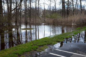 flooding in a countryside parking lot at the beginning of spring