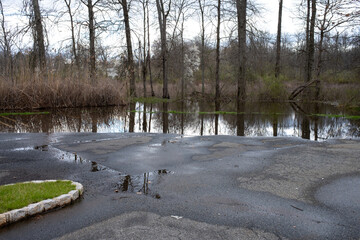 flooding in a countryside parking lot at the beginning of spring