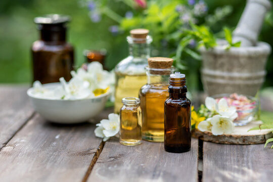 Assortment of organic essential oils, herbal extracts and medical flowers herbs In glass bottles. Alternative therapy, aromatherapy. Natural ingredients in cosmetic and medicine. 