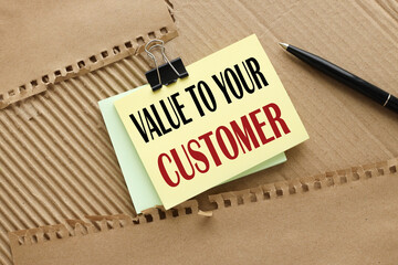 top view on bright note paper. words VALUE TO YOUR CUSTOMERS,