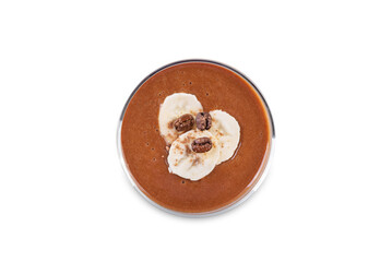 Coffee banana smoothie in a glass on a white isolated background
