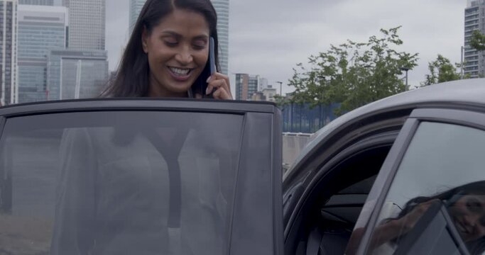 Chauffeur Opening vehicle door for Female Executive Businesswoman