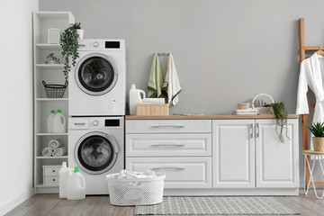 Laundry room with washing machines and white counters