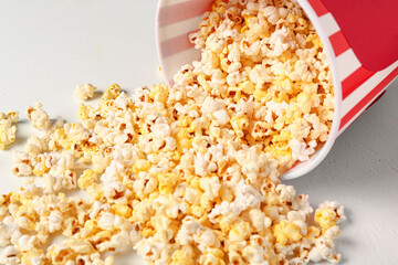 Bucket with tasty popcorn on white background