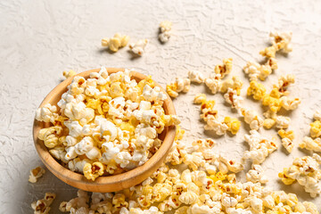 Bowl with tasty popcorn on white background