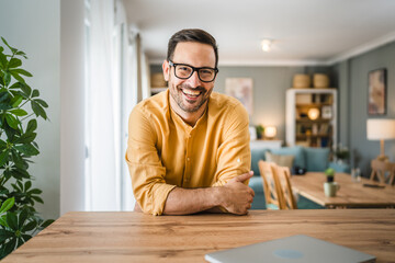 One adult man with eyeglasses stand at home happy smile