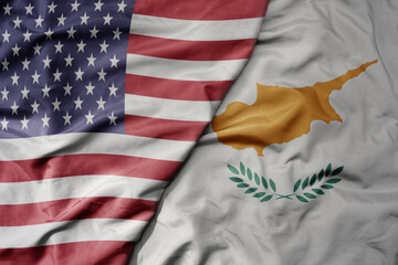 big waving colorful flag of united states of america and national flag of cyprus .