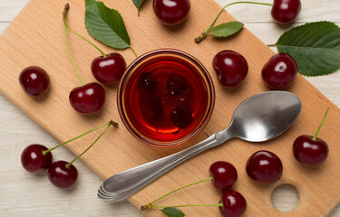 Flat lay with cherry jam on wooden backgroung