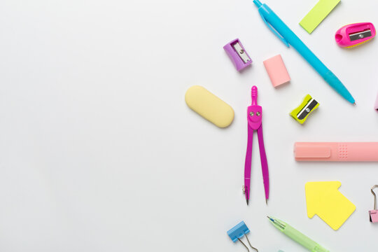Flat lay with colorful school stationery on white backgroung, top view