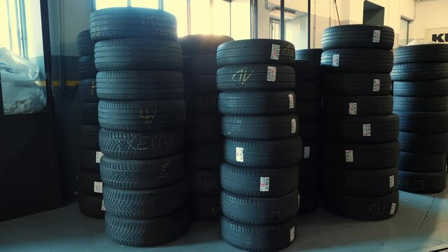 Tire fitting. Tires. Rubber tires stacked on top of each other. Auto repair shop.
